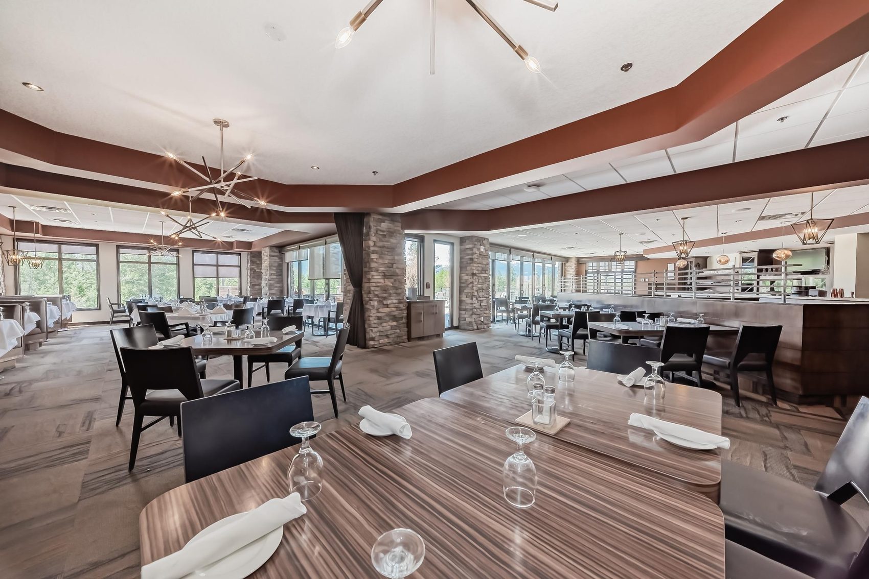 The dining room at Elements Restaurant & Bar, with tables set under tall windows